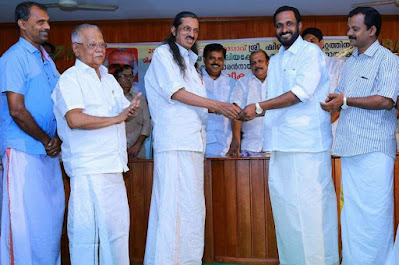 Receiving honors from MP Pannian Raveendran